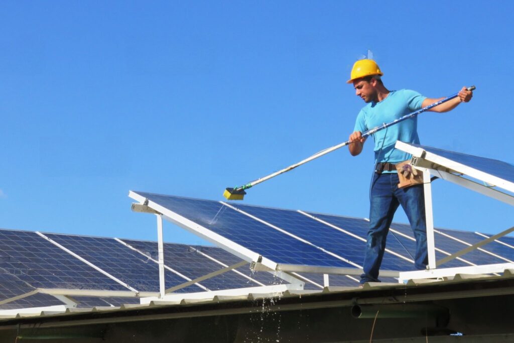 man cleaning a solar panel in San Diego California