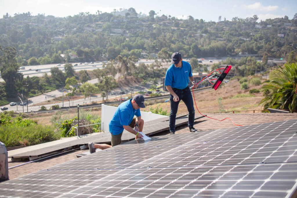 Skilled young worker maintaining solar panels in San Diego.